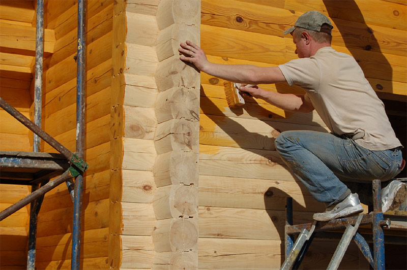 Coloration d'une nouvelle maison en bois avec des antiseptiques